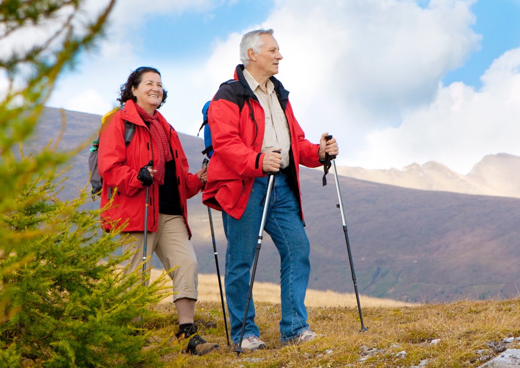 cute seniorcouple hiking in an autumn mountainlandscape