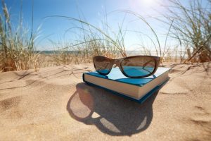 35905322 - book and sunglasses on the beach for summer reading and relaxing